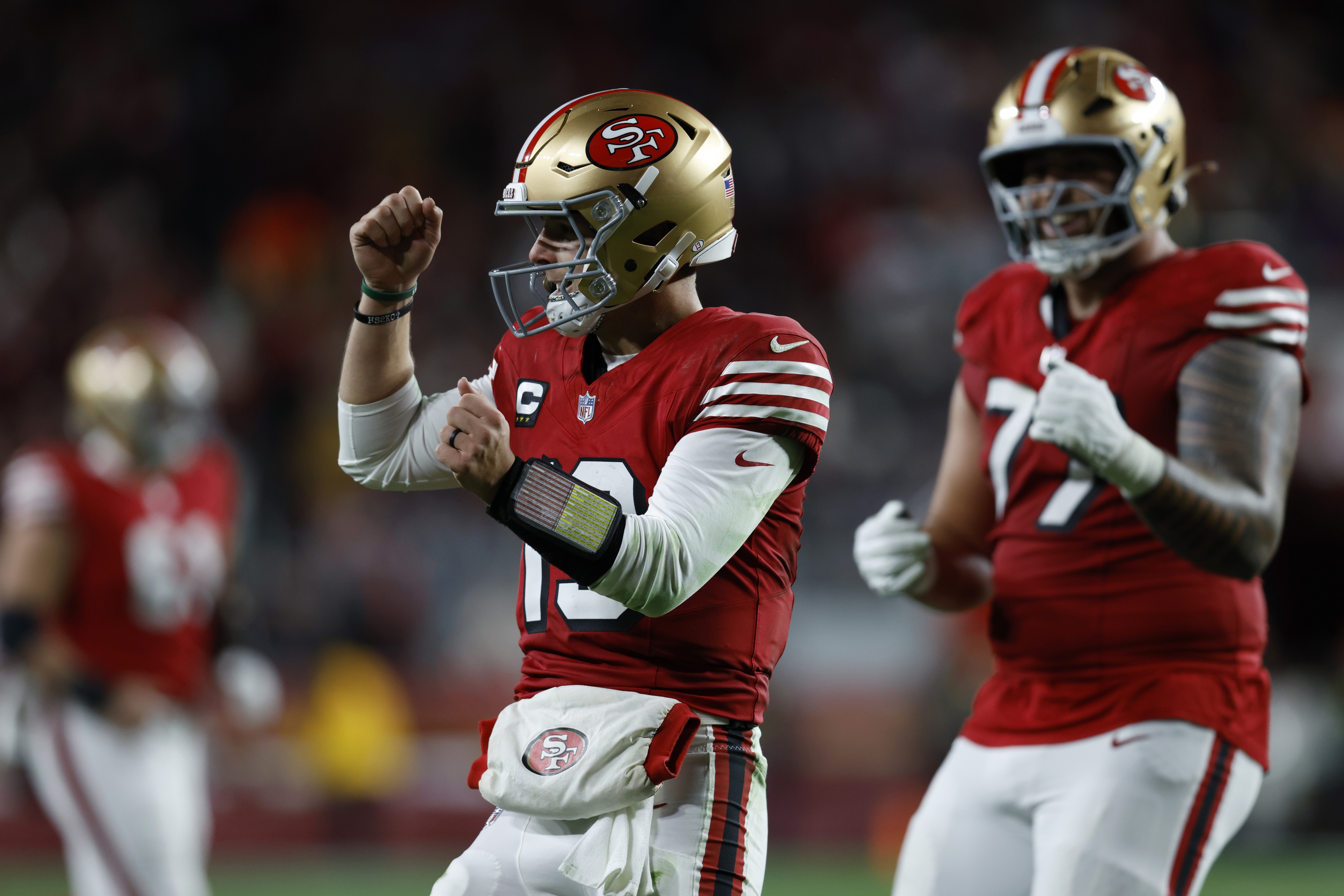 Brock Purdy celebrates a TD as we offer our Seahawks vs. 49ers predictions and opening odds.