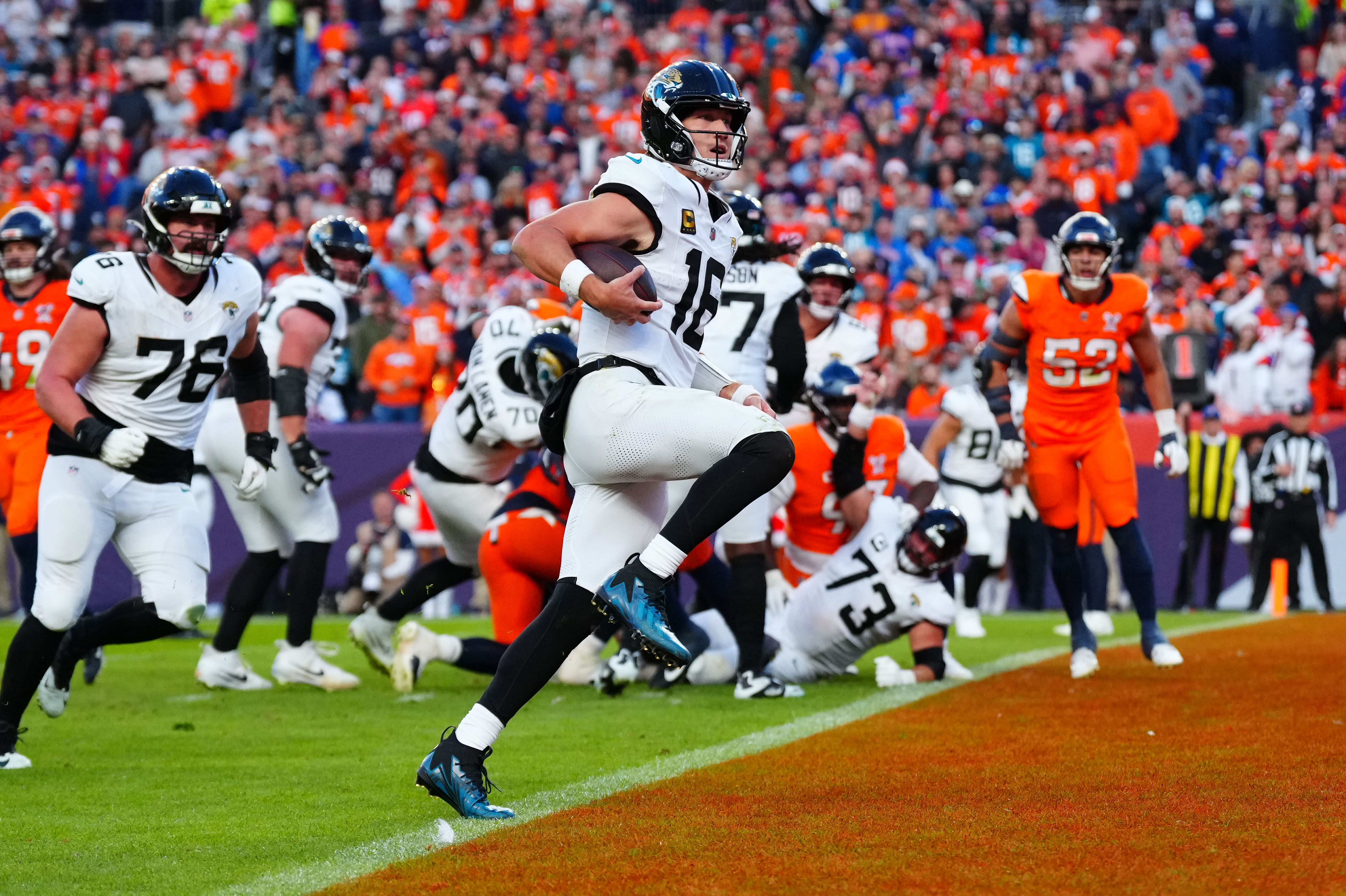 Jacksonville Jaguars quarterback Trevor Lawrence (16) rushes for a touchdown against the Denver Broncos as we break down their Super Bowl odds.