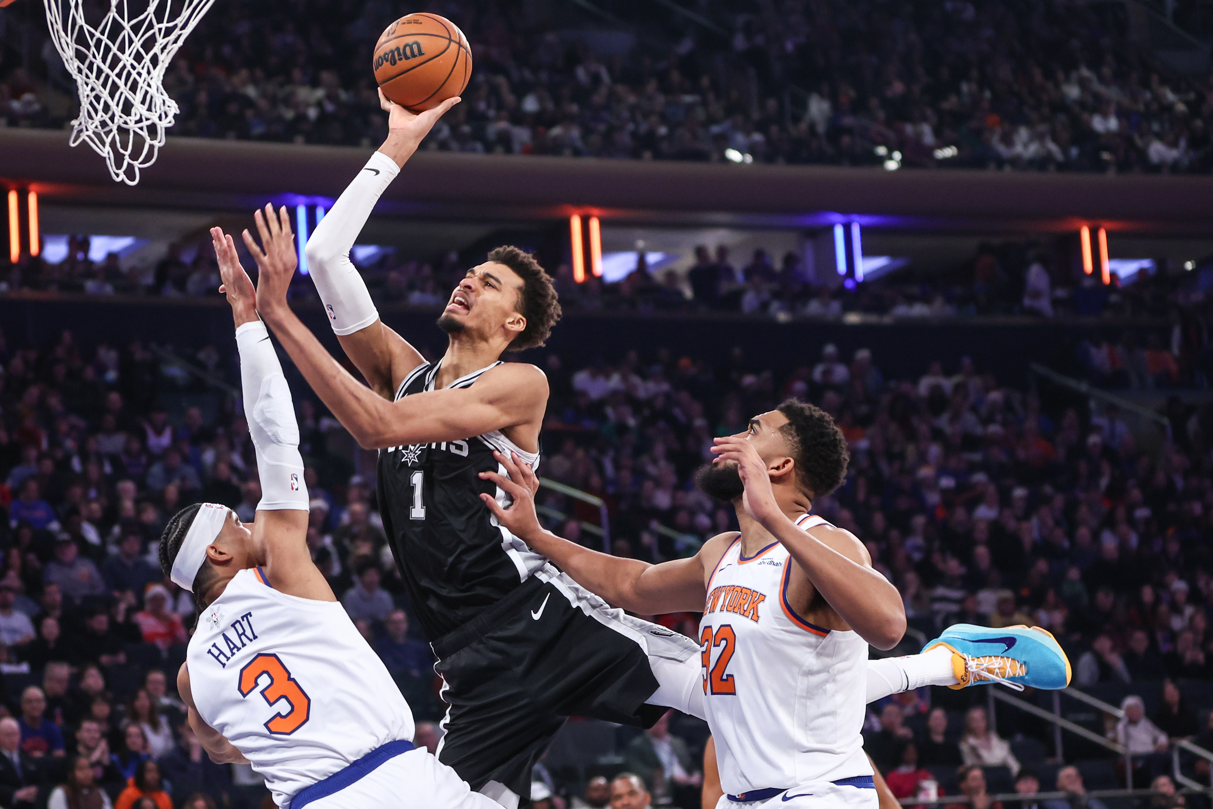 San Antonio Spurs center Victor Wembanyama (1) shoots over New York Knicks guard Josh Hart (3) as we provide our Spurs vs. Knicks player props today.