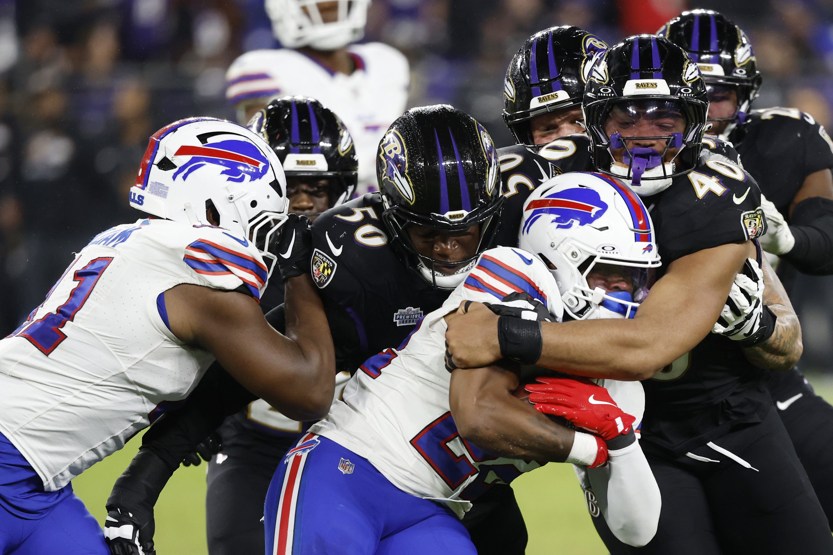 Buffalo Bills running back Ray Davis is tackled as we offer our NFL Divisional Round picks and preview for all four games this weekend.