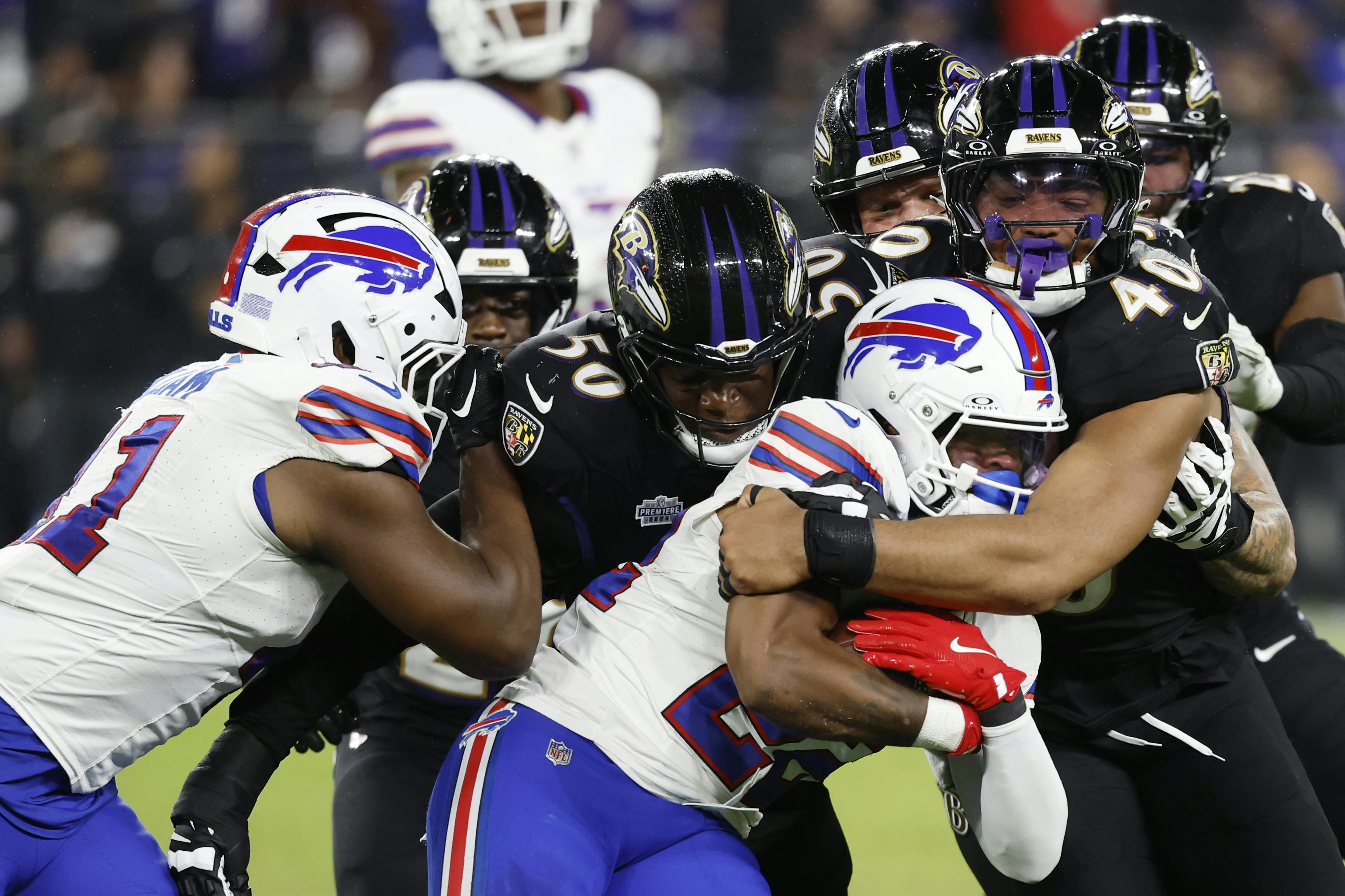 Buffalo Bills running back Ray Davis is tackled as we offer our NFL Divisional Round picks and preview for all four games this weekend.