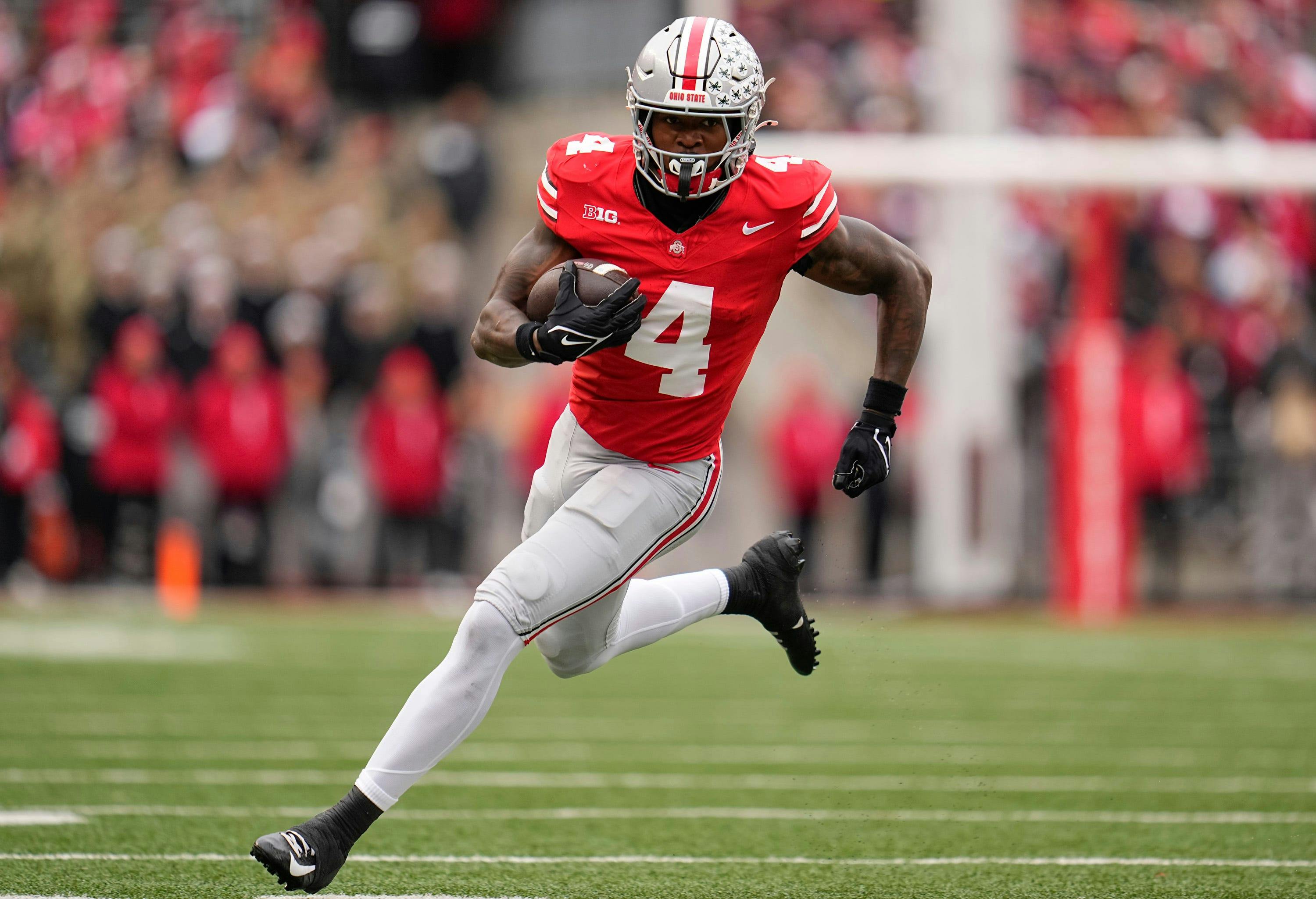 Ohio State wide receiver Jeremiah Smith runs after making a catch against Indiana. The Buckeyes lead the Big Ten Championship odds. 