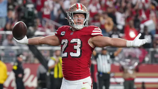 San Francisco 49ers running back Christian McCaffrey (23) celebrates after a touchdown as we break down our 49ers vs. Texans player prop bets.