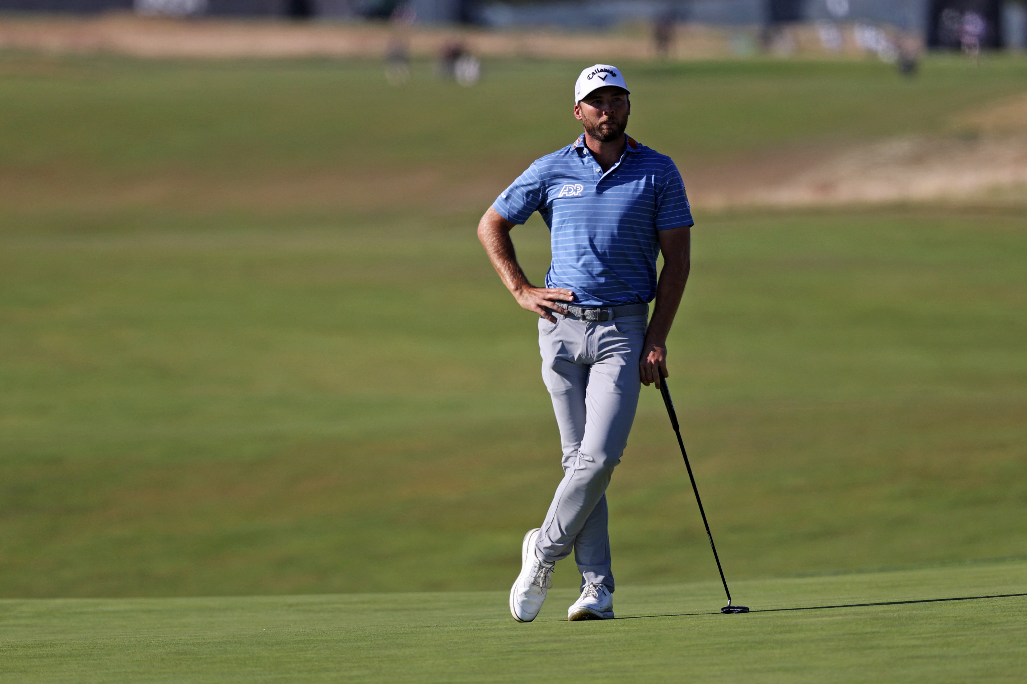 Sam Burns lines up his putt on the 18th green as he is featured in our Travelers Championship picks & predictions.