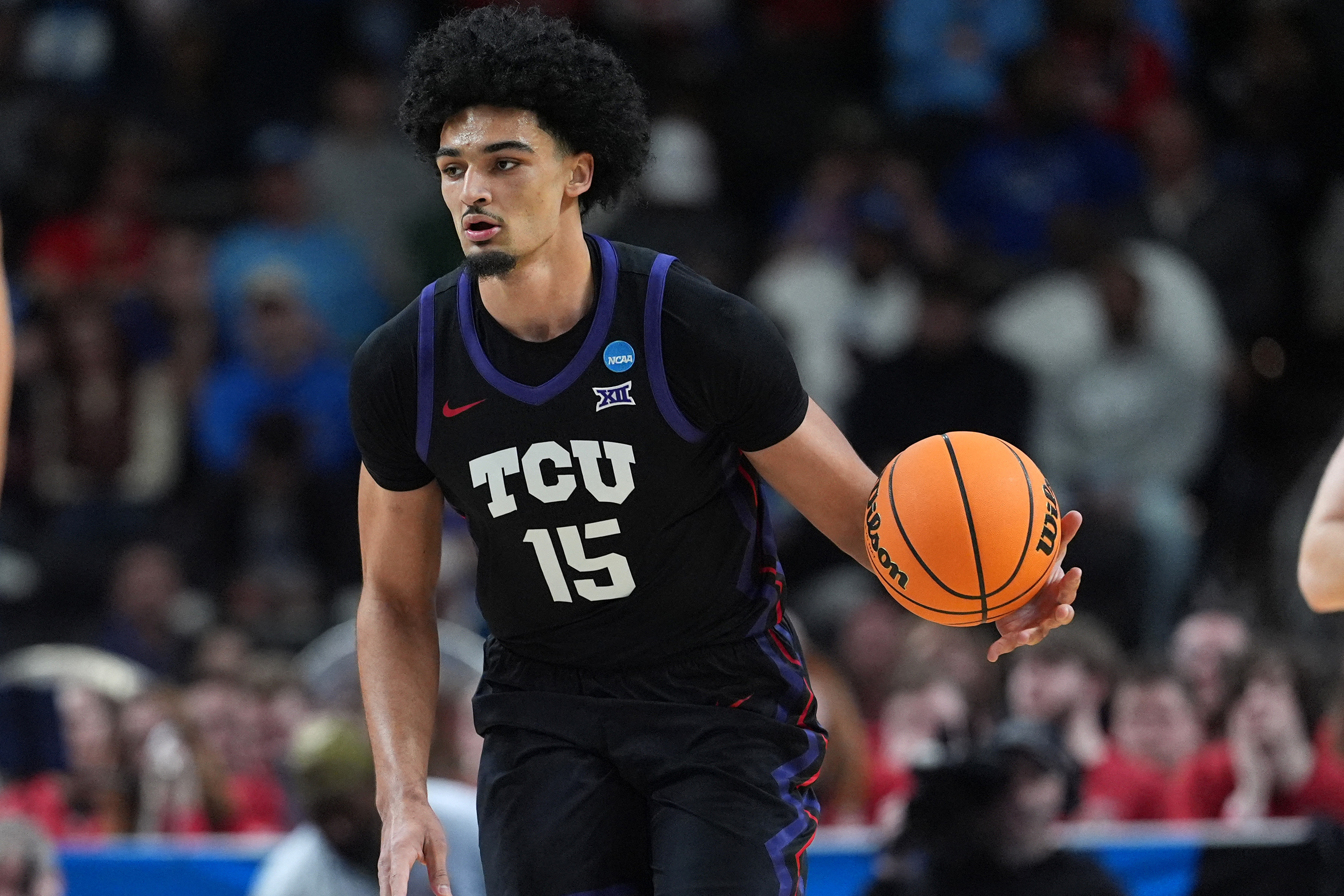 TCU Horned Frogs forward David Punch (15), featured in our TCU vs. Duke prediction, dribbles against Ohio State during the first round at Bon Secours Wellness Arena.