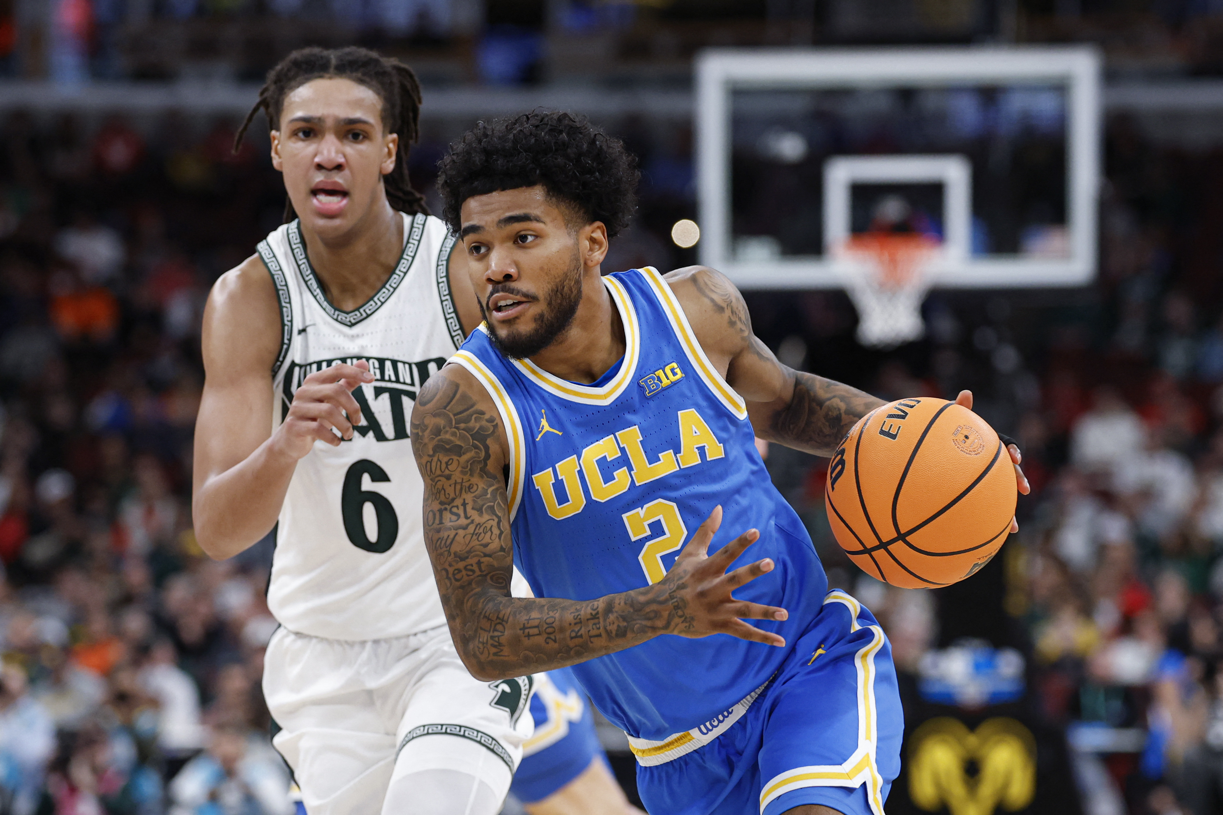 UCLA Bruins guard Donovan Dent drives to the basket as we make our best UCF vs. UCLA predictions. 