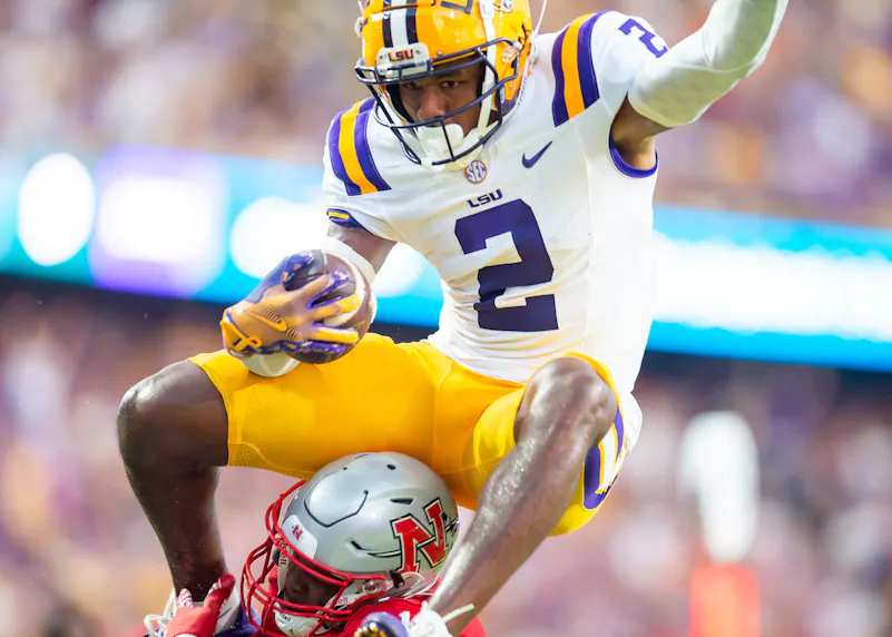 LSU's Kyren Lacy leaps over a defender to score a touchdown against Nicholls. We're backing Lacy in our college football expert picks Week 3.