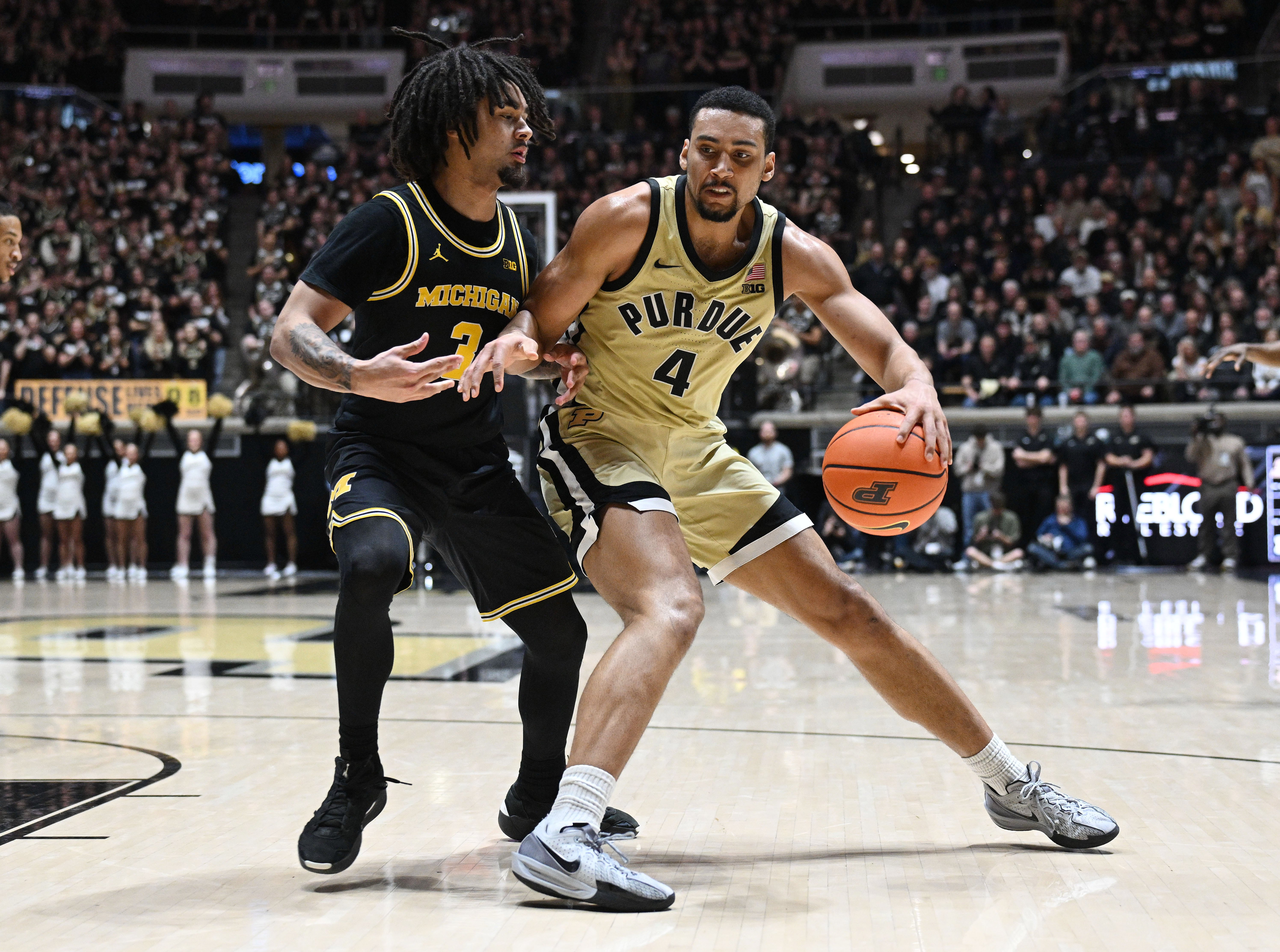 Purdue Boilermakers forward Trey Kaufman-Renn leans in against Michigan Wolverines guard Elliot Cadeau as we make our best Purdue vs. Michigan prediction