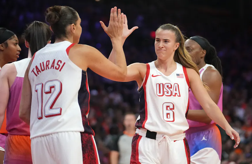 Team USA guard Sabrina Ionescu (6) high-fives teammate Diana Taurasi (12) as we offer our best Japan vs. USA prediction and expert picks for the Olympic women's basketball tournament matchup on Monday in the Paris 2024 Olympics.