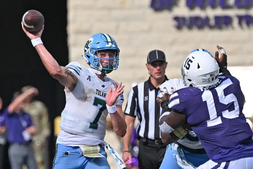 Quarterback Michael Pratt of the Tulane Green Wave throws a pass against pressure from guard Robert Hentz II of the Kansas State Wildcats.