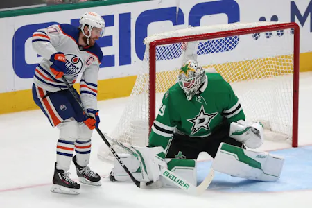 Connor McDavid plays the puck in front of Jake Oettinger during the second period in Game 5 as Gary Pearson offers his best props and predictions for Sunday's Game 6 of the Western Final between the Oilers and Stars. 