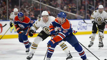 Connor McDavid #97 of the Edmonton Oilers skates against Charlie McAvoy #73 of the Boston Bruins as we look at the Stanley Cup odds