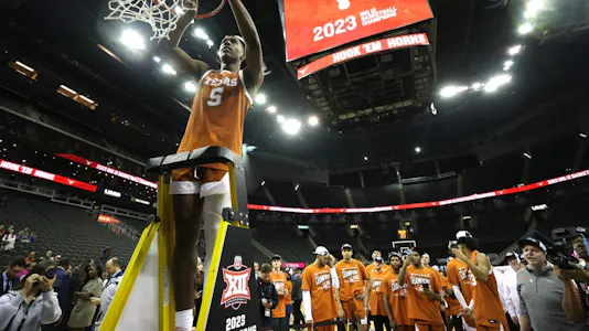 Marcus Carr of the Texas Longhorns celebrates by cutting down the net as we look at the top March Madness MVP predictions.