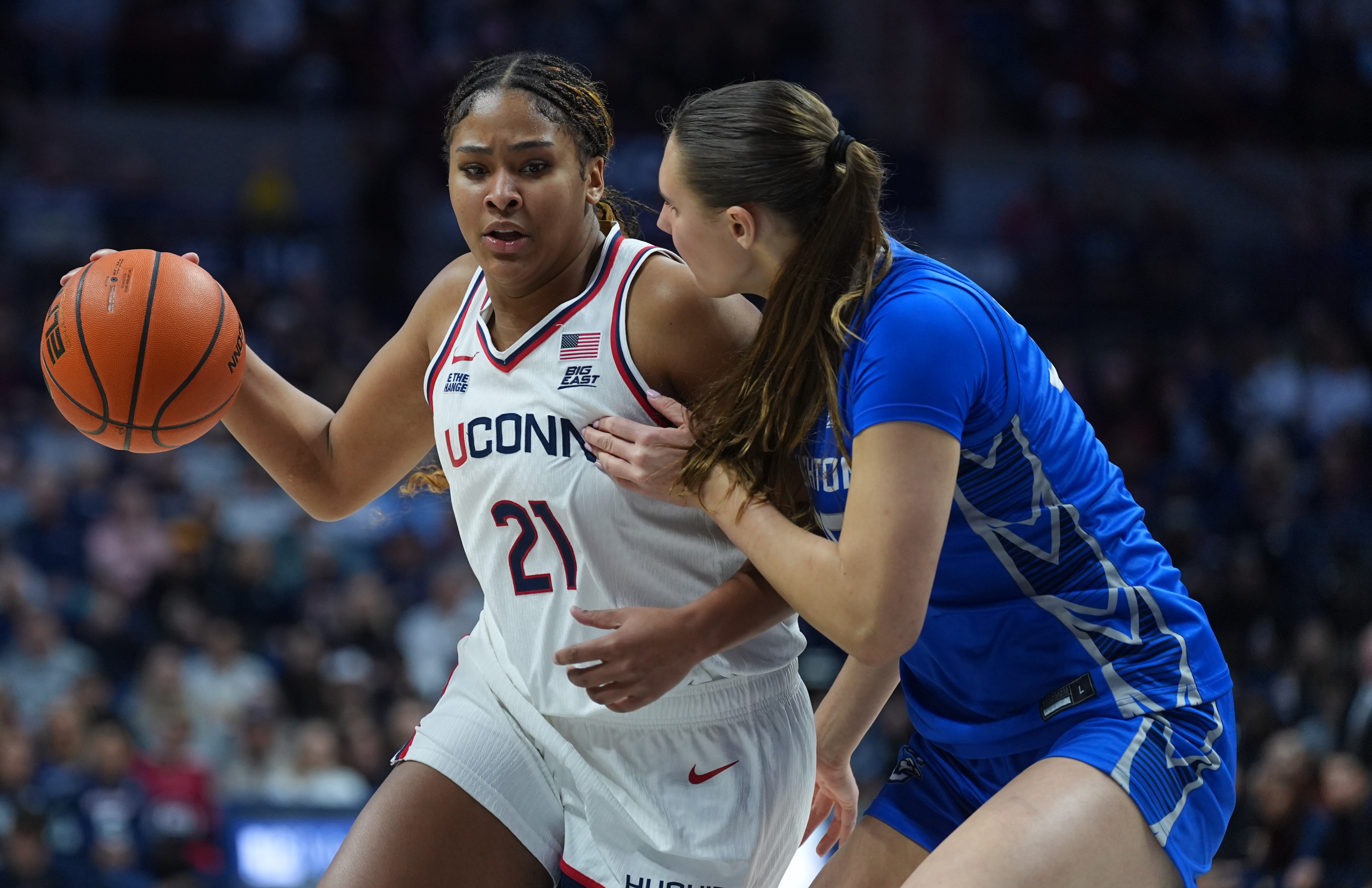 UConn Huskies forward Sarah Strong (21) drives the ball against Creighton Bluejays center Elizabeth Gentry (35). UConn is favored by the women's March Madness odds.