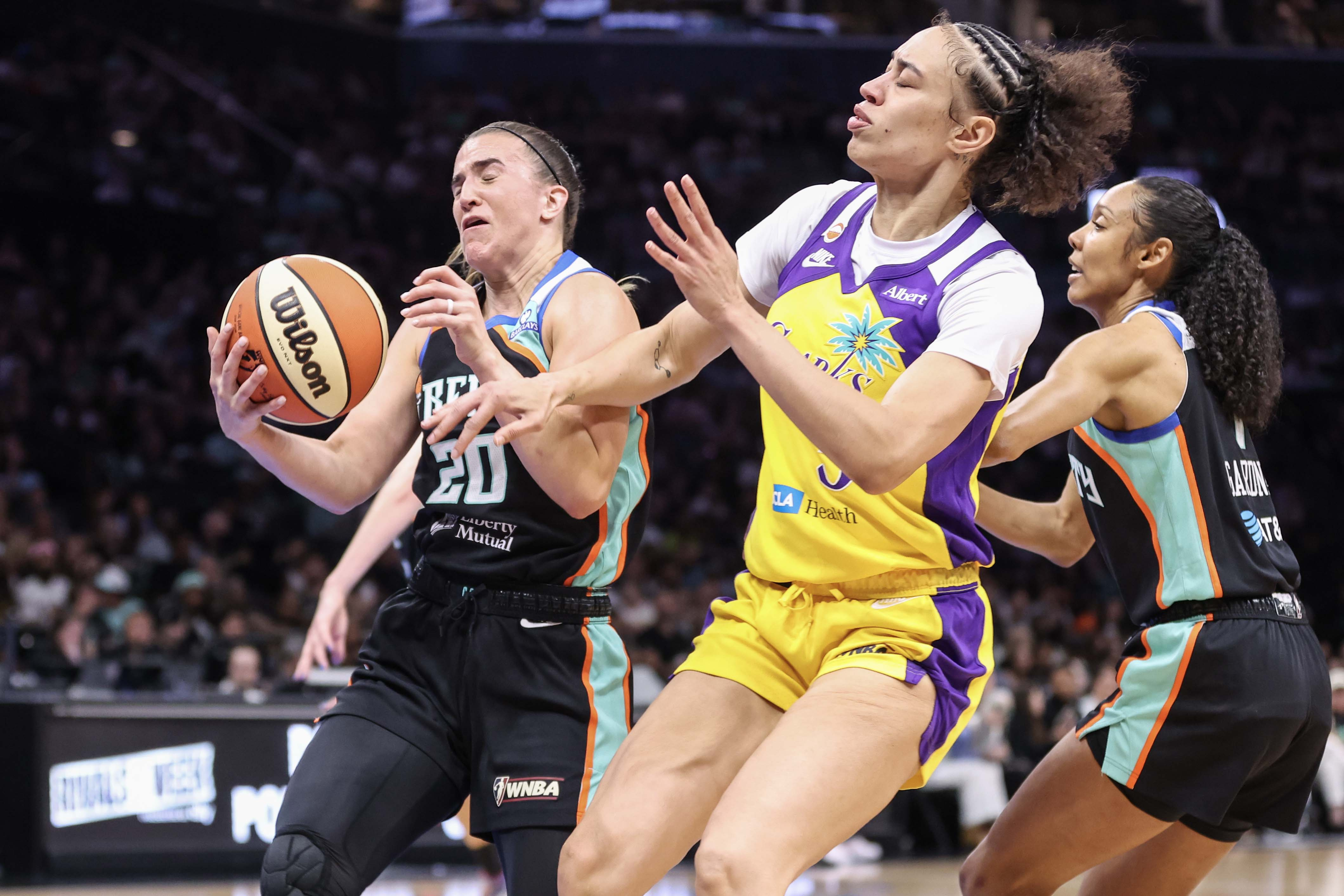 New York Liberty guard Sabrina Ionescu (20) collides with Los Angeles Sparks forward Dearica Hamby (5) in the first quarter at Barclays Center. 