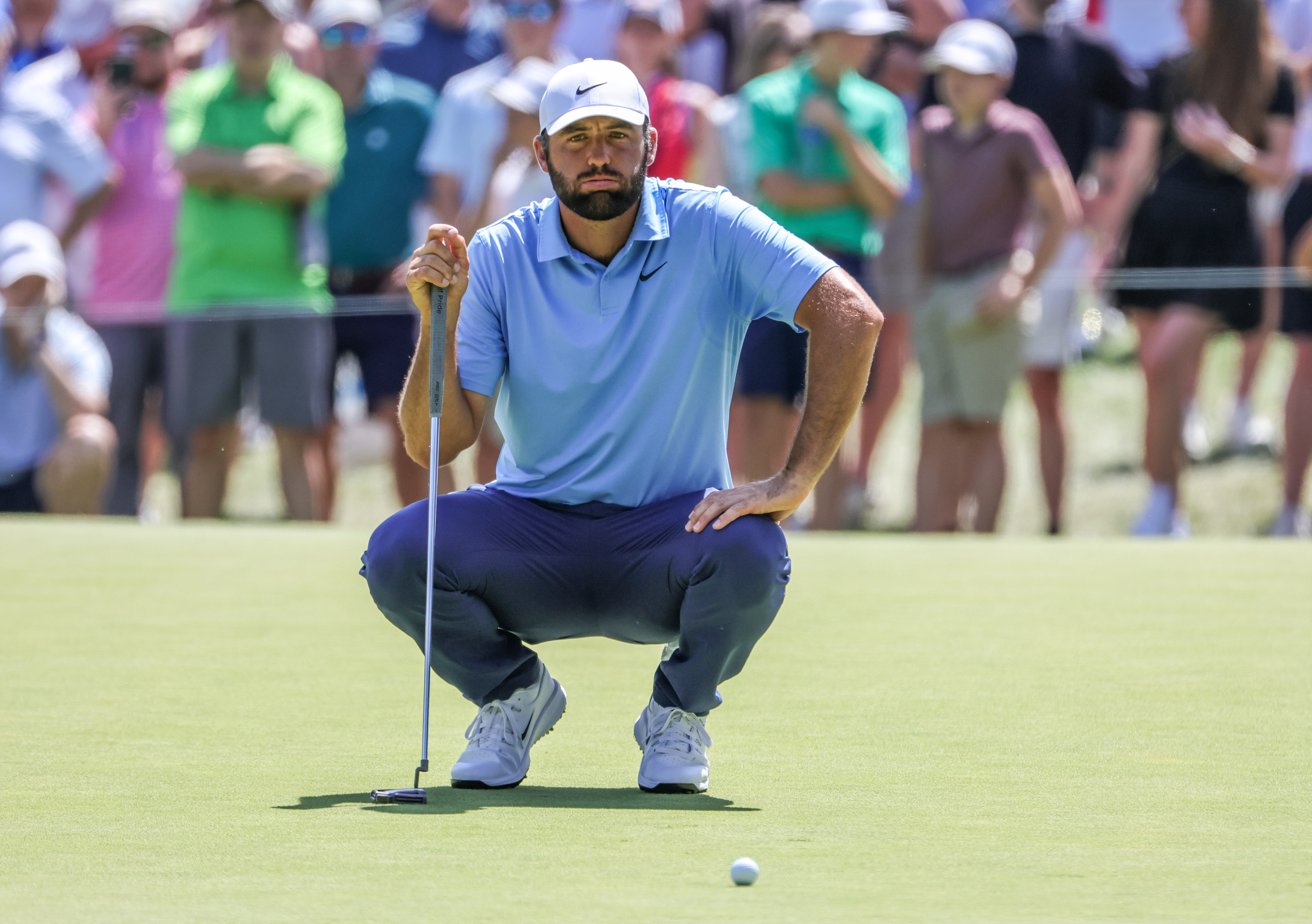 Scottie Scheffler of the United States lines up a putt on the 9th hole as he is featured i our TOUR Championship odds & favorites.