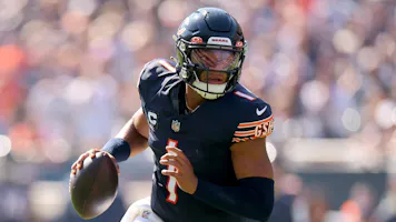 Justin Fields of the Chicago Bears scrambles with the ball against the Denver Broncos, and we offer new U.S. bettors our exclusive bet365 bonus code.