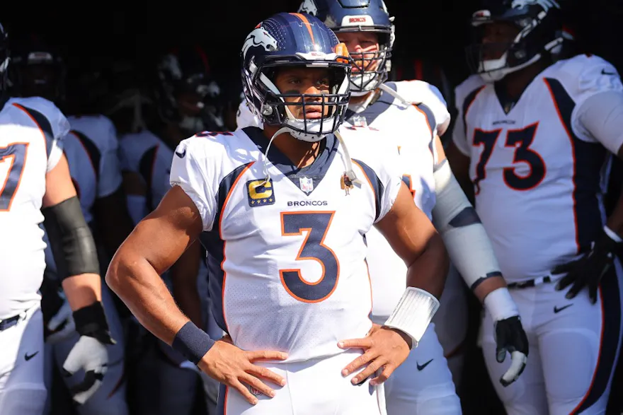 Russell Wilson of the Denver Broncos exits the tunnel with teammates before the game against the Chicago Bears, and we offer our top Patriots vs. Broncos SGP based on the best NFL odds.