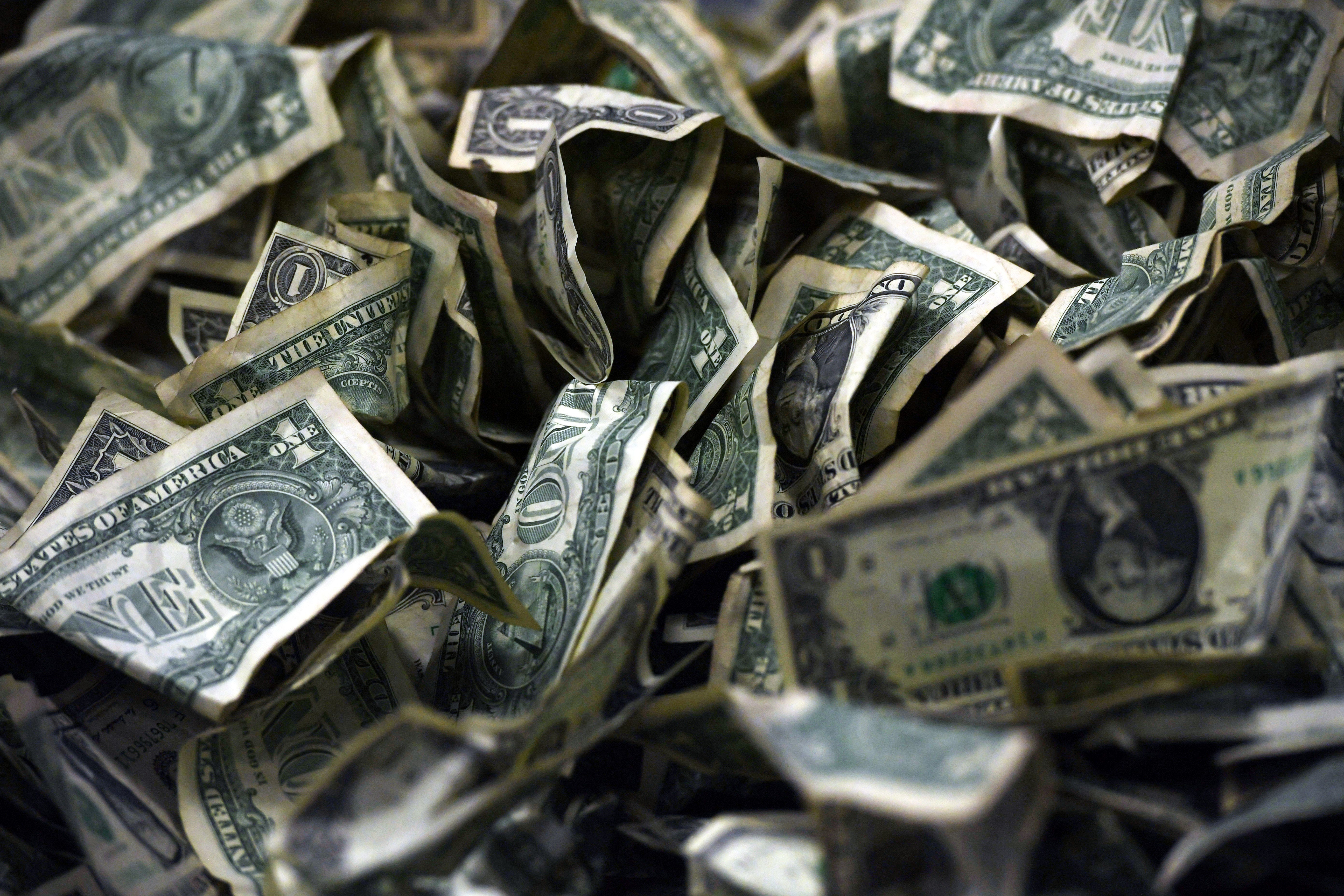 A pile of dollar bills sits on a table as we look at Novig's handle from its opening week as a prediction market operator. 