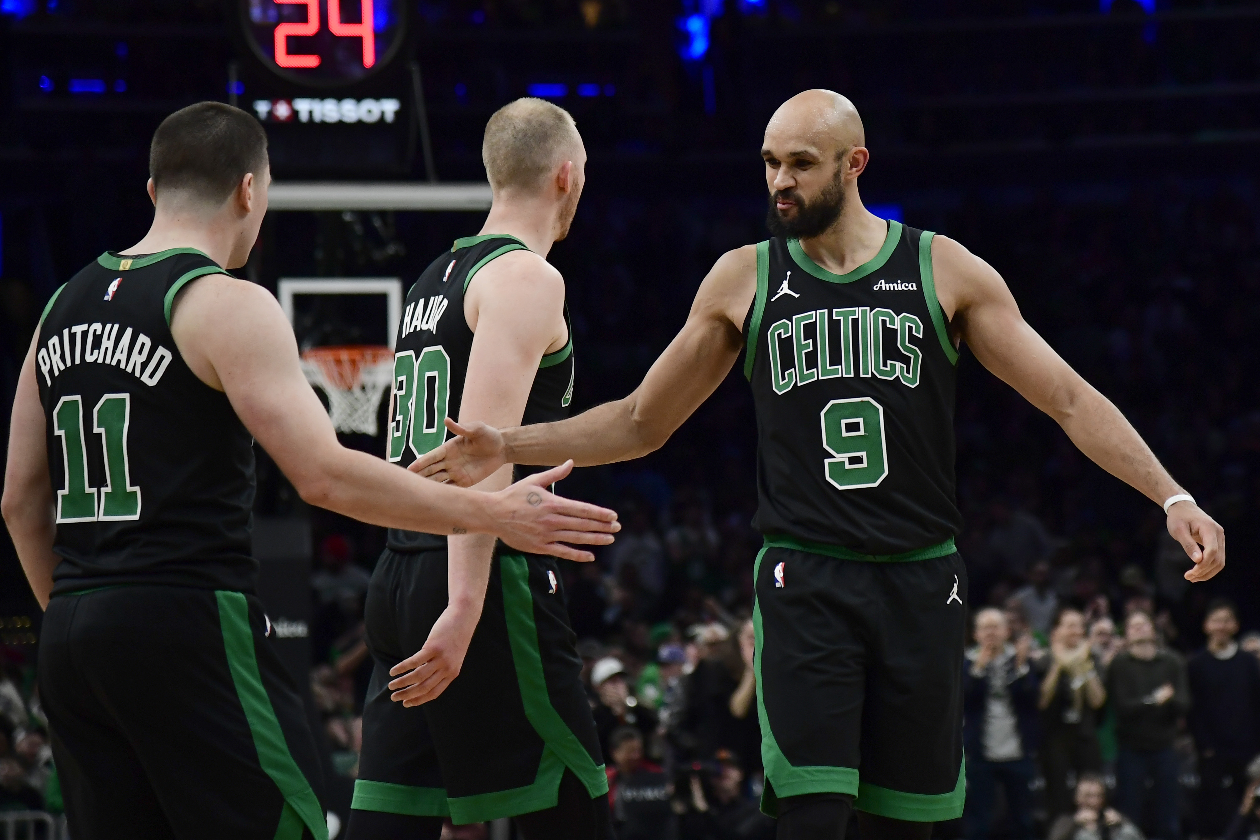Boston Celtics guard Derrick White (9) congratulates guard Payton Pritchard (11) as we offer our Knicks vs. Celtics player props today.