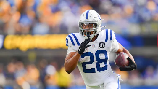 Pictured: Indianapolis Colts running back Jonathan Taylor (28) carries the ball as we offer our Titans vs. Colts player prop bets.