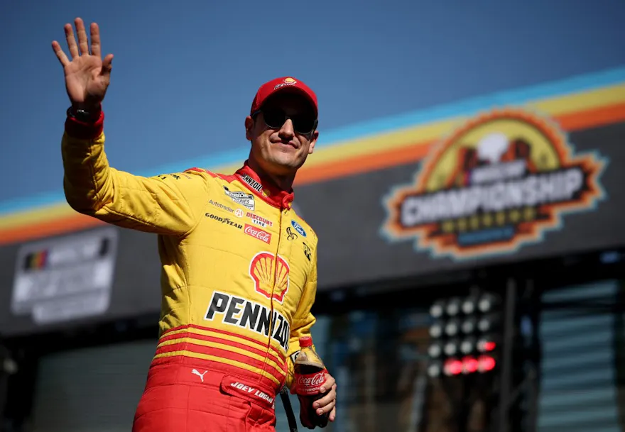 Joey Logano waves to fans as he walks onstage during driver intros prior to the NASCAR Cup Series Championship at Phoenix Raceway as we look at our Dayton 500 predictions.