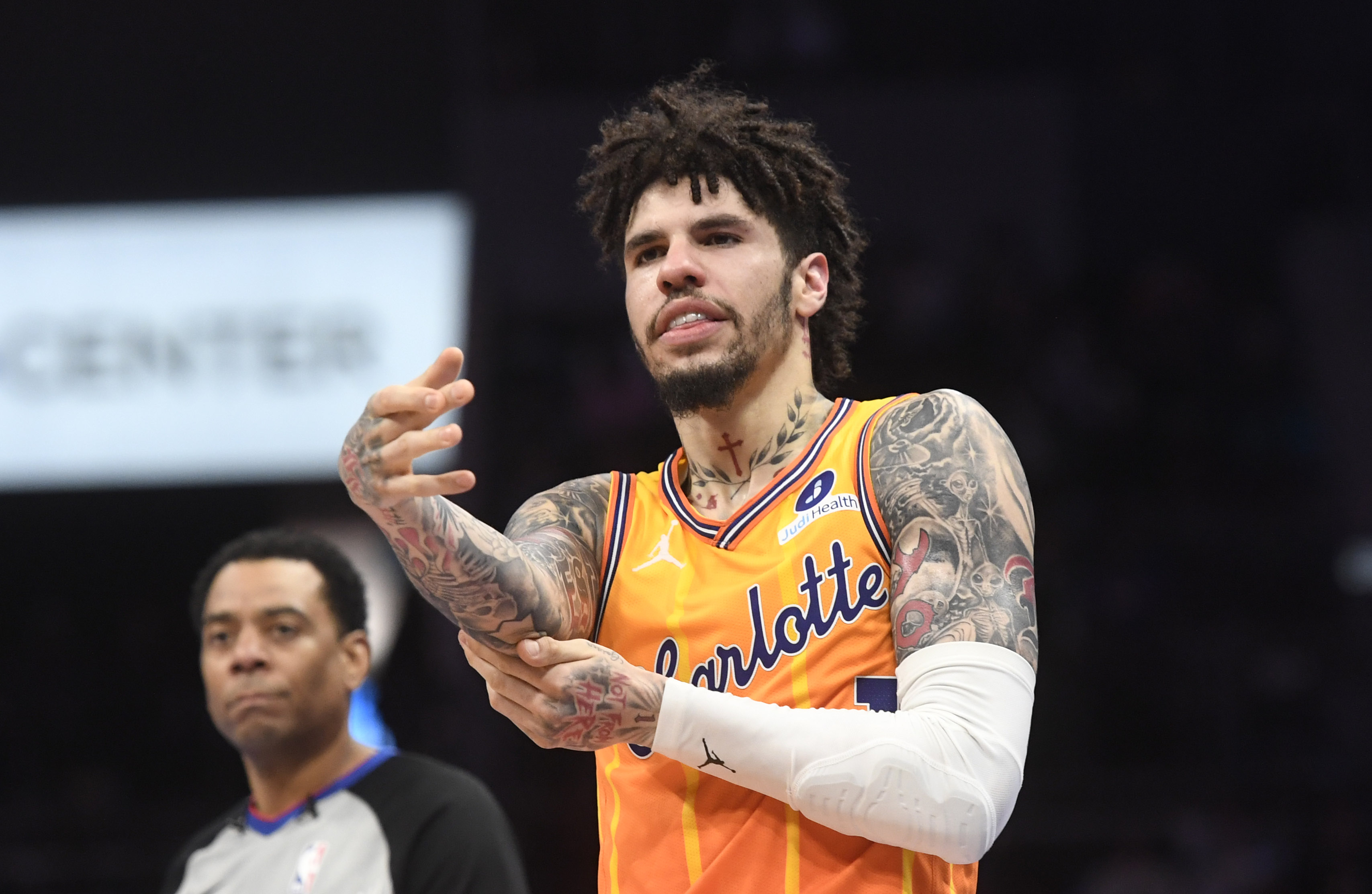 Charlotte Hornets guard LaMelo Ball (1), seen here rubbing his elbow after falling, is featured in our best NBA player props tonight.