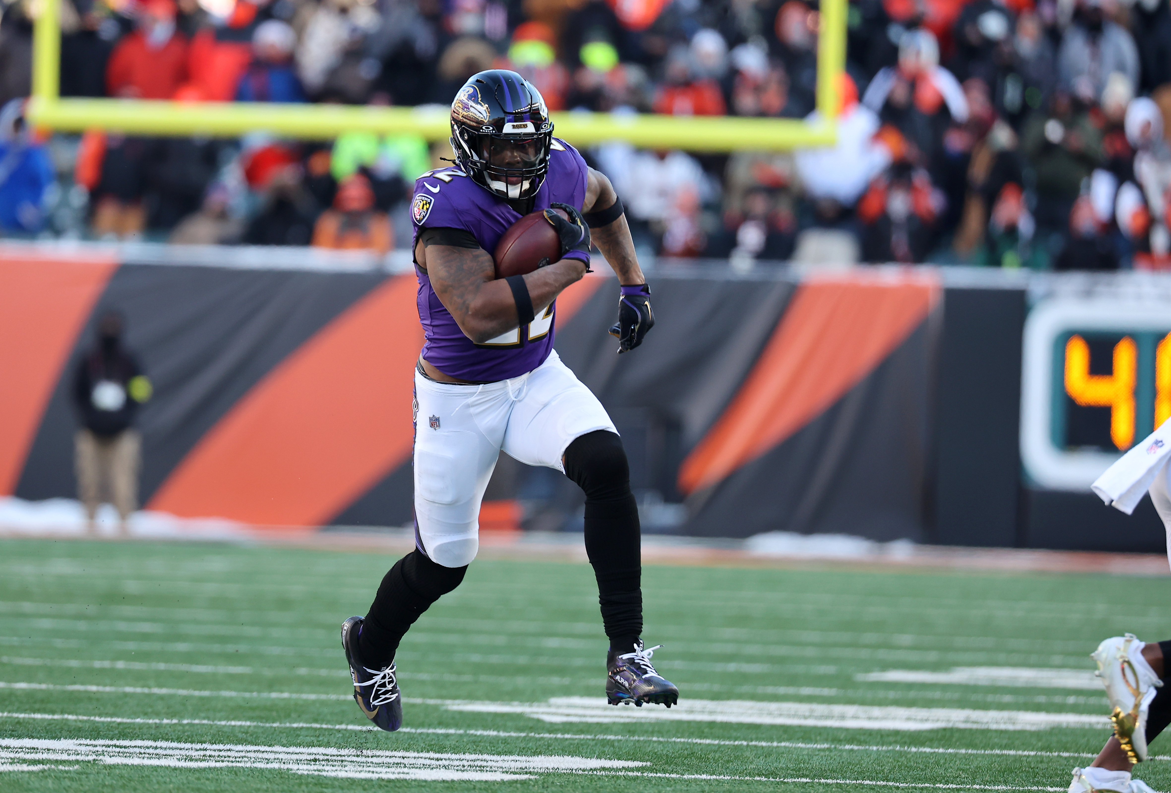 Baltimore Ravens running back Derrick Henry (22) runs for a first down as he is featured in our Patriots vs. Ravens player prop bets for Sunday Night Football.