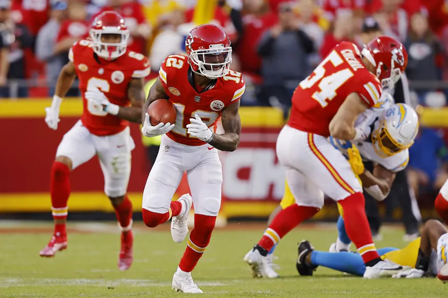 Mecole Hardman Jr. #12 of the Kansas City Chiefs runs with the ball as we make our Dolphins vs. Chiefs prediction