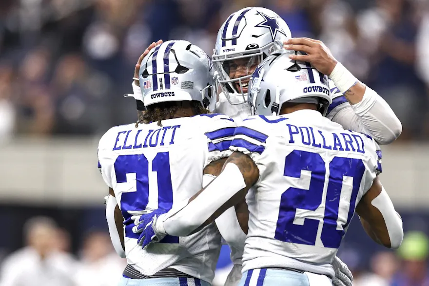 Dak Prescott of the Dallas Cowboys celebrates with Ezekiel Elliott and Tony Pollard after a touchdown against the Detroit Lions at AT&T Stadium on Oct. 23, 2022 in Arlington, Texas.