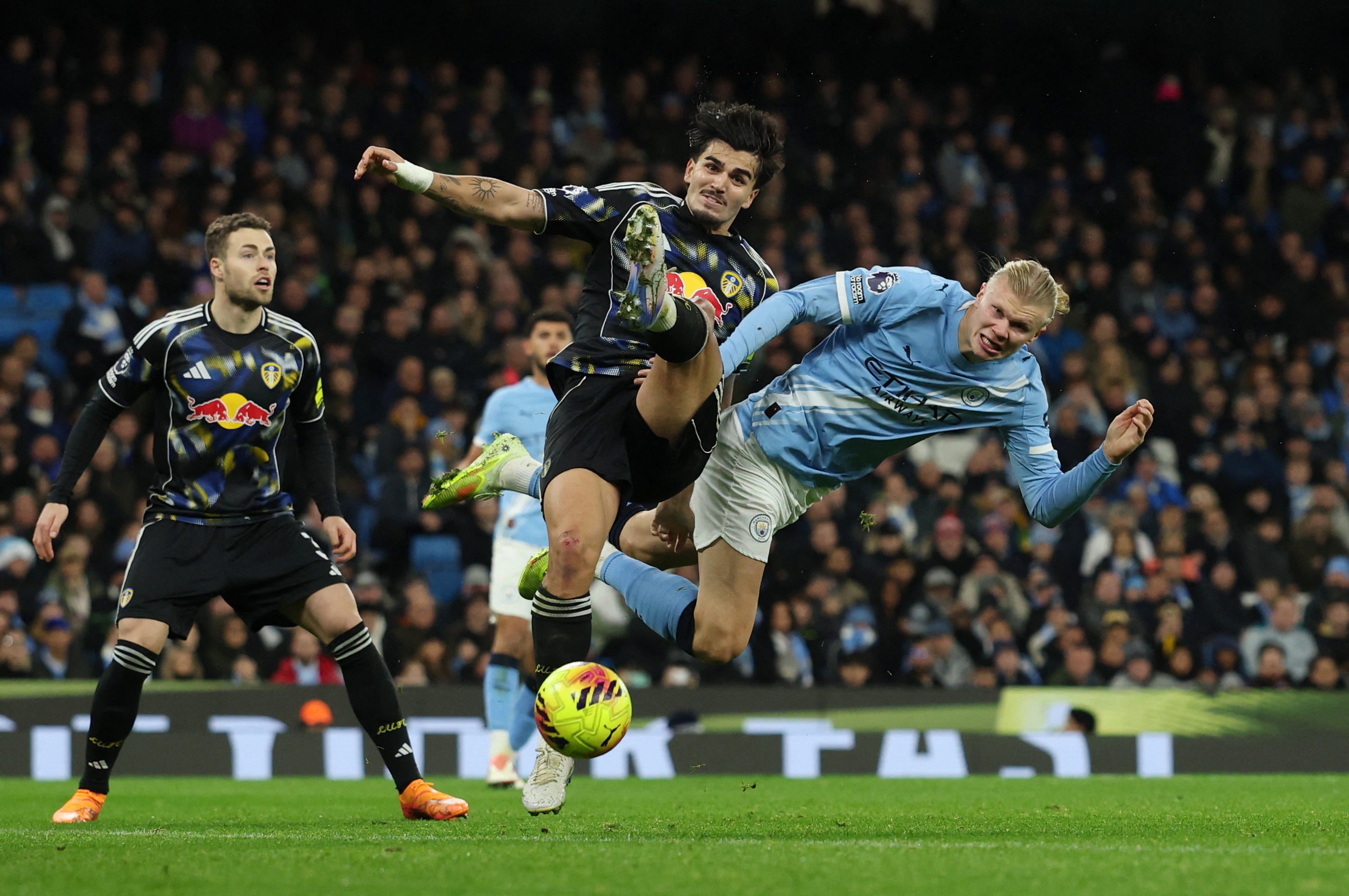 Manchester City's Erling Haaland in action with Leeds United's Pascal Struijk as we make our best Leeds vs. Man City prediction.