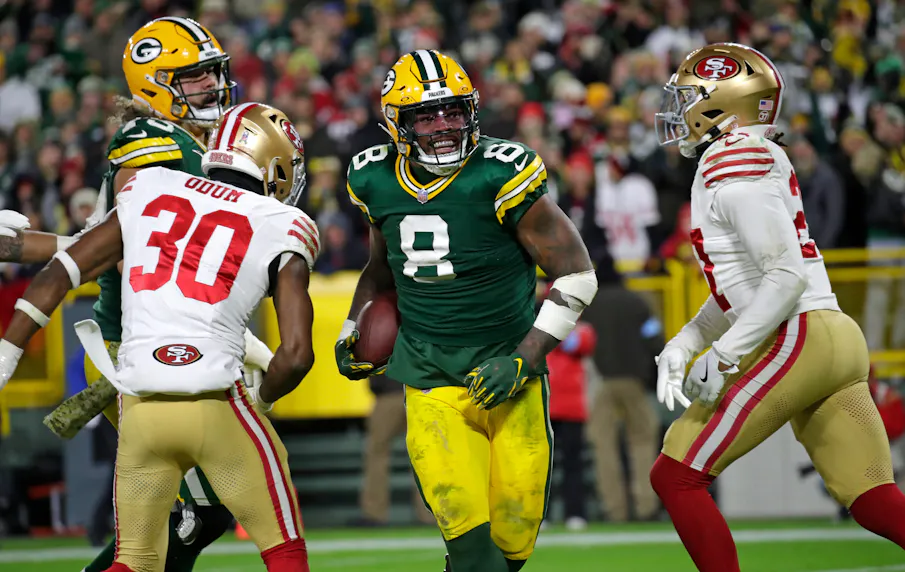 Green Bay Packers running back Josh Jacobs celebrates scoring a touchdown against the San Francisco 49ers. We're backing Green Bay in our Dolphins vs. Packers early picks.