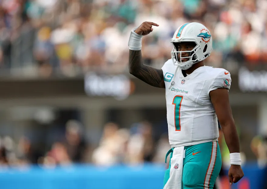 Tua Tagovailoa #1 of the Miami Dolphins signals as he returns to the field and we look at our best NFL Week 2 predictions