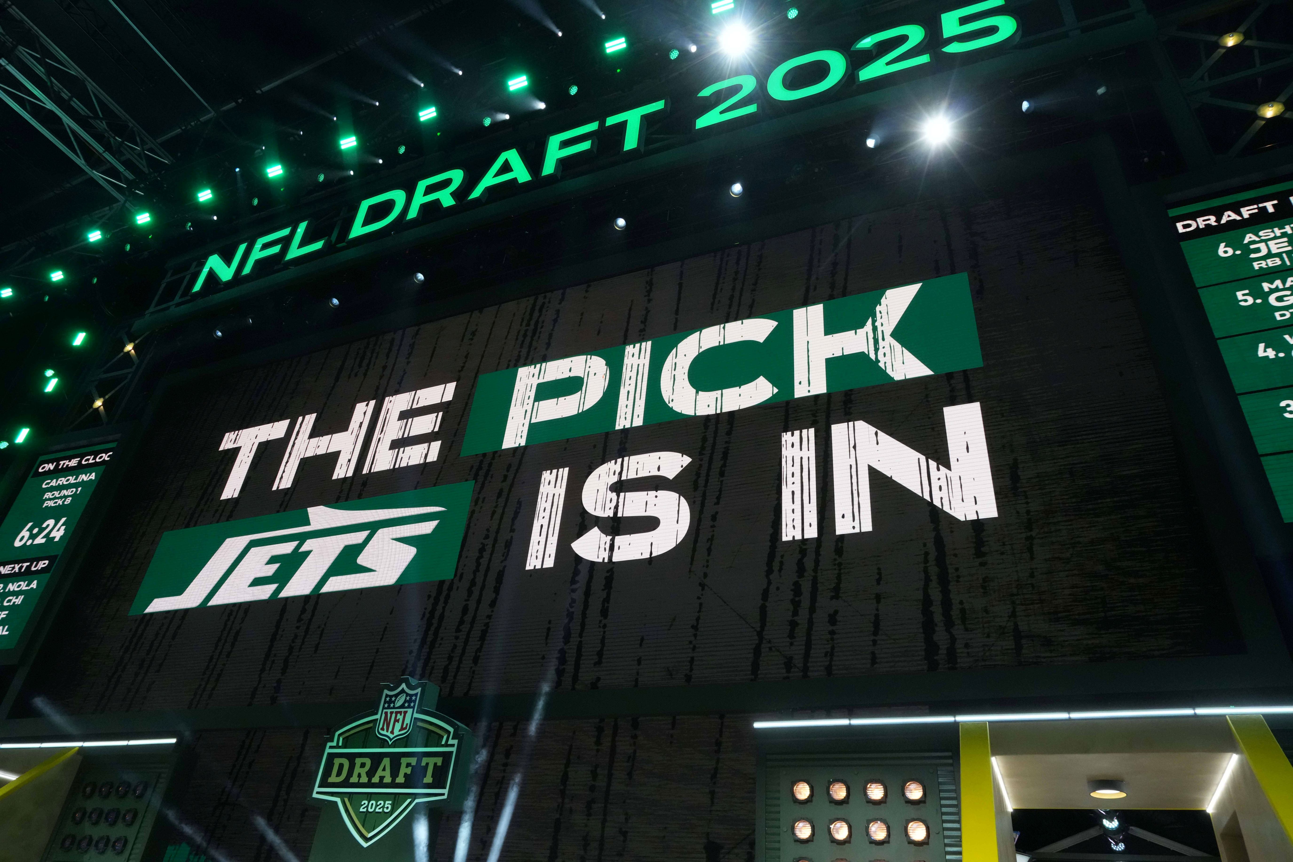 The New York Jets logo is projected on the video board during the NFL Draft at Lambeau Field.