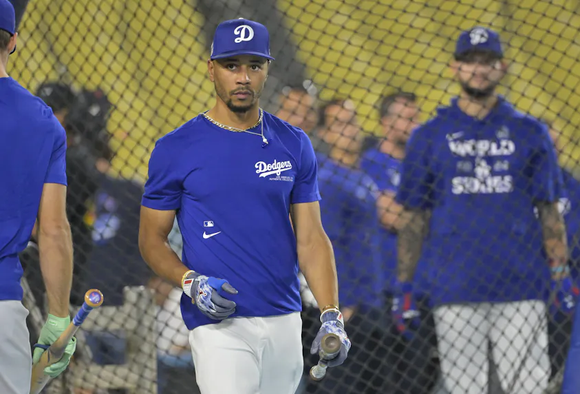 Los Angeles Dodgers right fielder Mookie Betts during the team workout prior to Game 1 of the World Series, and we're offering our World Series predictions for this exciting matchup between the Yankees and Dodgers.