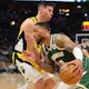 Milwaukee Bucks guard Damian Lillard (0) drives around Indiana Pacers wing Doug McDermott (20) as we offer our best Pacers vs. Bucks player props for Game 2 on Tuesday.