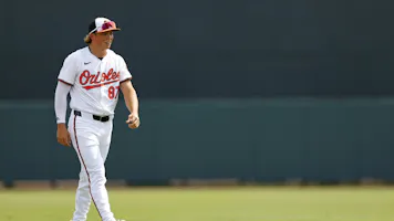 Jackson Holliday of the Baltimore Orioles looks on during a spring training game against the Pittsburgh Pirates, and we look at the best Jackson Holliday futures odds and predictions based on the best MLB odds.