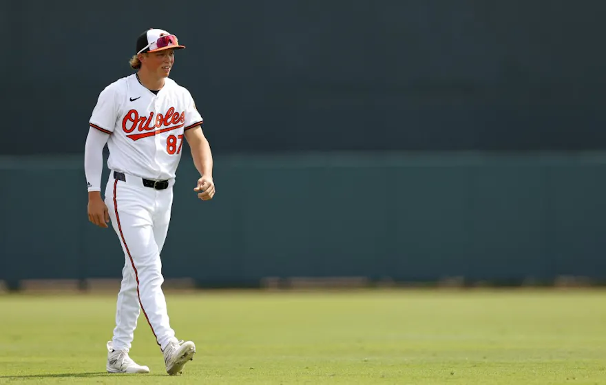 Jackson Holliday of the Baltimore Orioles looks on during a spring training game against the Pittsburgh Pirates, and we look at the best Jackson Holliday futures odds and predictions based on the best MLB odds.