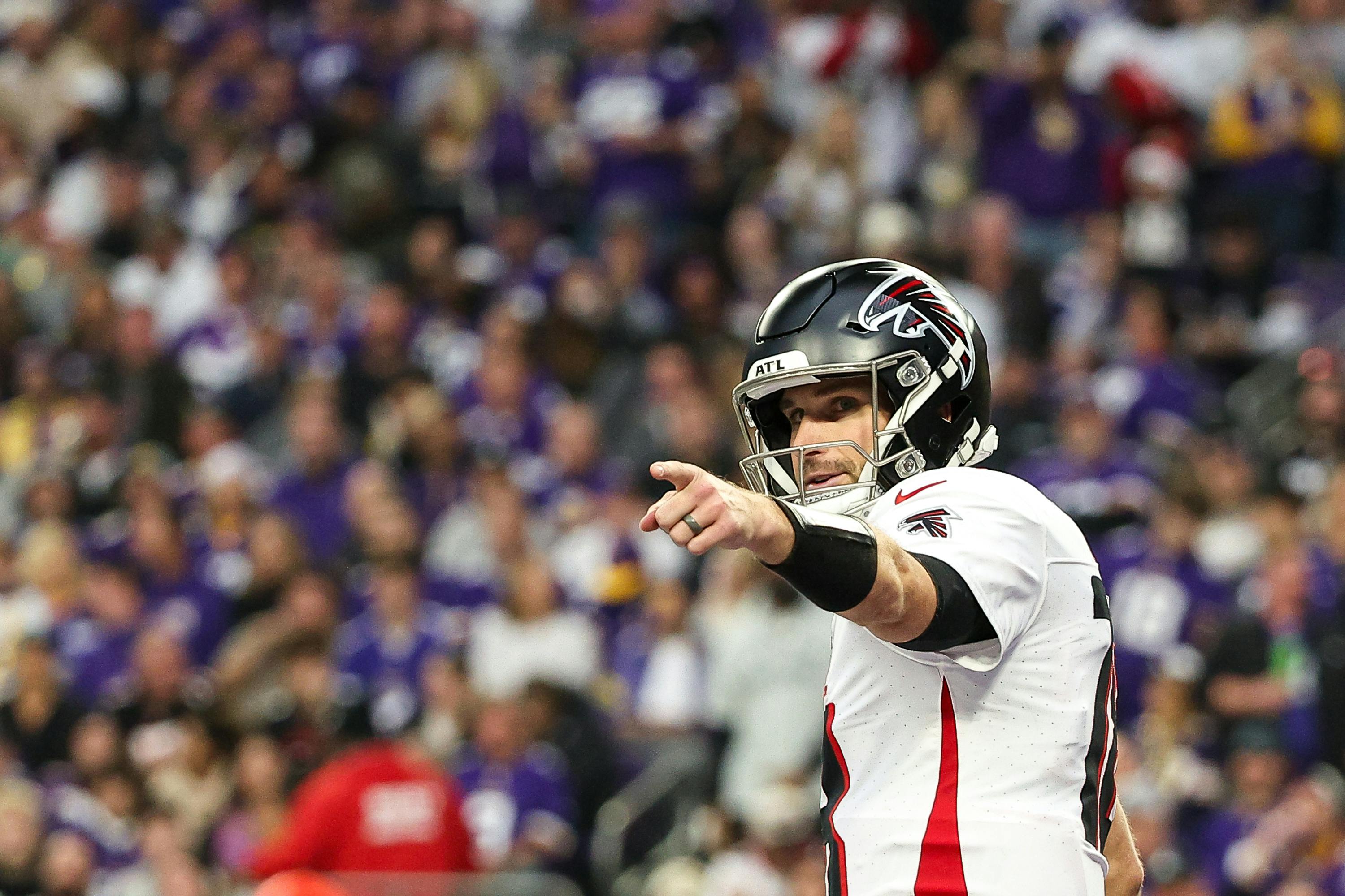 Atlanta Falcons quarterback Kirk Cousins celebrates running back Bijan Robinson