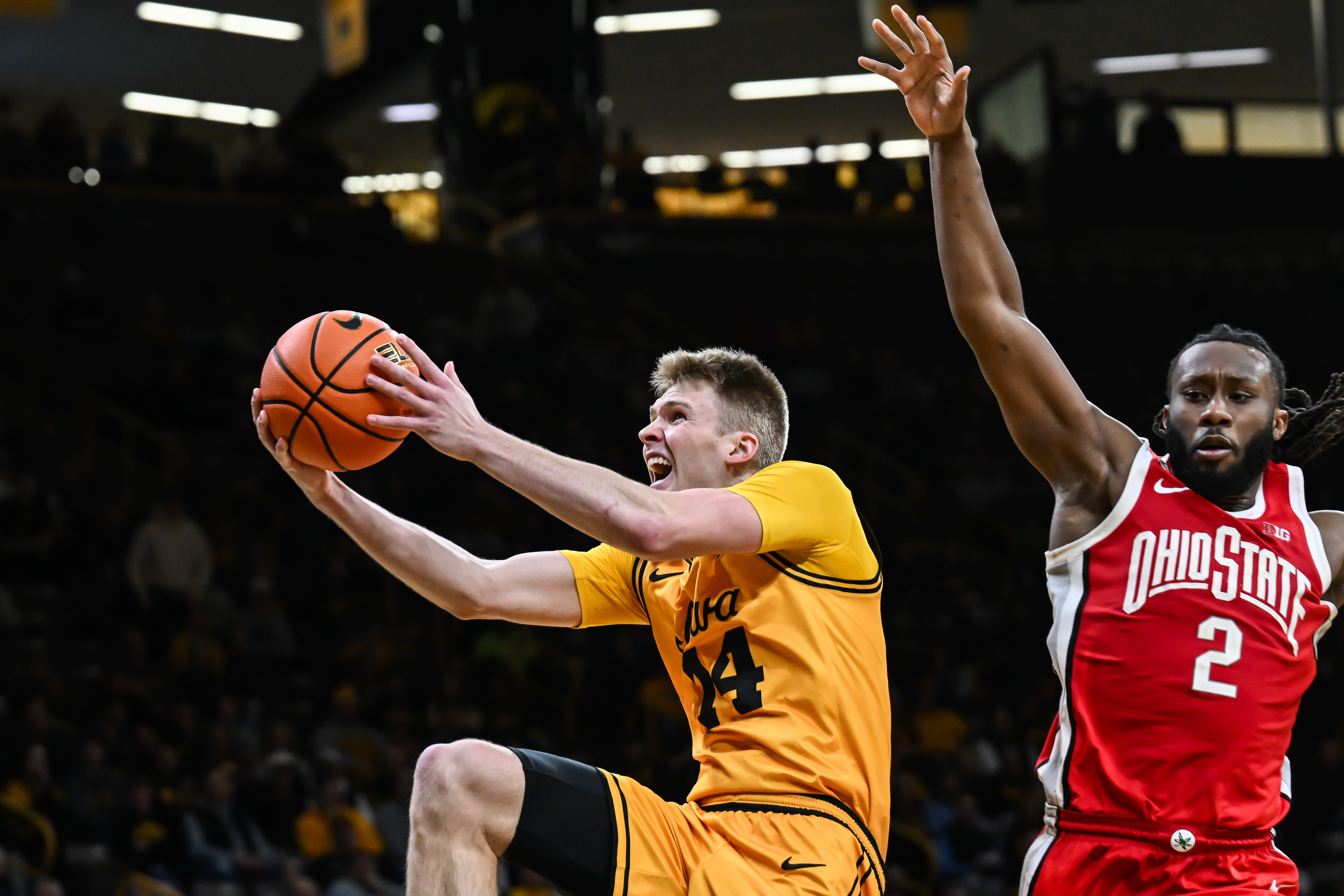 Iowa Hawkeyes guard Bennett Stirtz (14) goes to the basket as we break down our Michigan vs. Iowa prediction & odds.