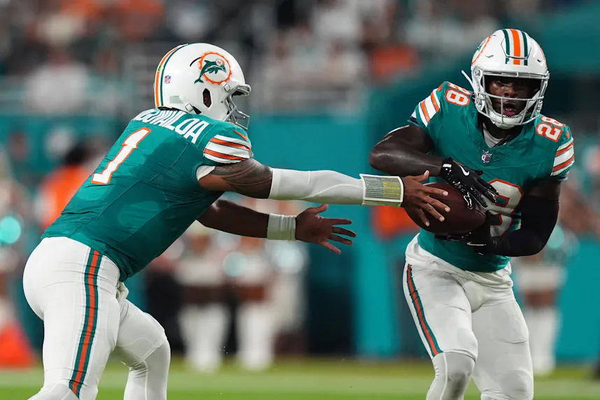 Miami Dolphins quarterback Tua Tagovailoa hands the ball to running back De'Von Achane as we look at the best Week 9 NFL odds.