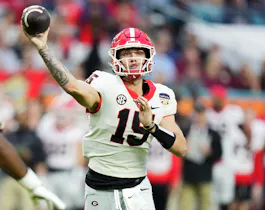 Carson Beck of the Georgia Bulldogs throws a pass in the second quarter against the Florida State Seminoles during the Capital One Orange Bowl. Georgia opened among the favorites by the 2025 College Football Playoff odds.