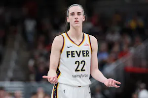 Caitlin Clark (22) of the Indiana Fever reacts as we offer our best Sky vs. Fever prediction and expert picks, including Caitlin Clark player props, for Saturday's Sky vs. Fever WNBA matchup at Gainbridge Fieldhouse in Indianapolis.