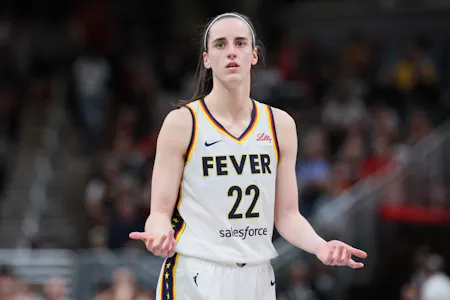 Caitlin Clark (22) of the Indiana Fever reacts as we offer our best Sky vs. Fever prediction and expert picks, including Caitlin Clark player props, for Saturday's Sky vs. Fever WNBA matchup at Gainbridge Fieldhouse in Indianapolis.