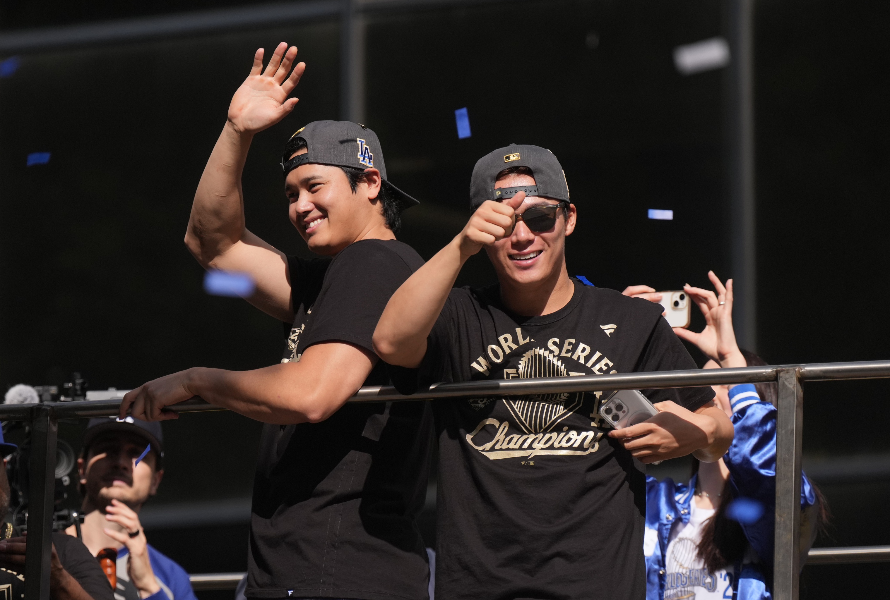 Los Angeles Dodgers two-way player Shohei Ohtani (17) and Los Angeles Dodgers pitcher Yoshinobu Yamamoto (18) - who are the World Series odds favorites again - wave to fans during the World Series championship parade and celebration.