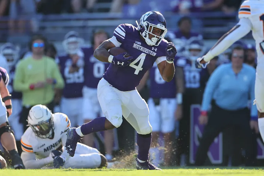 Cam Porter of the Northwestern Wildcats runs with the ball as we share our best college football player props.