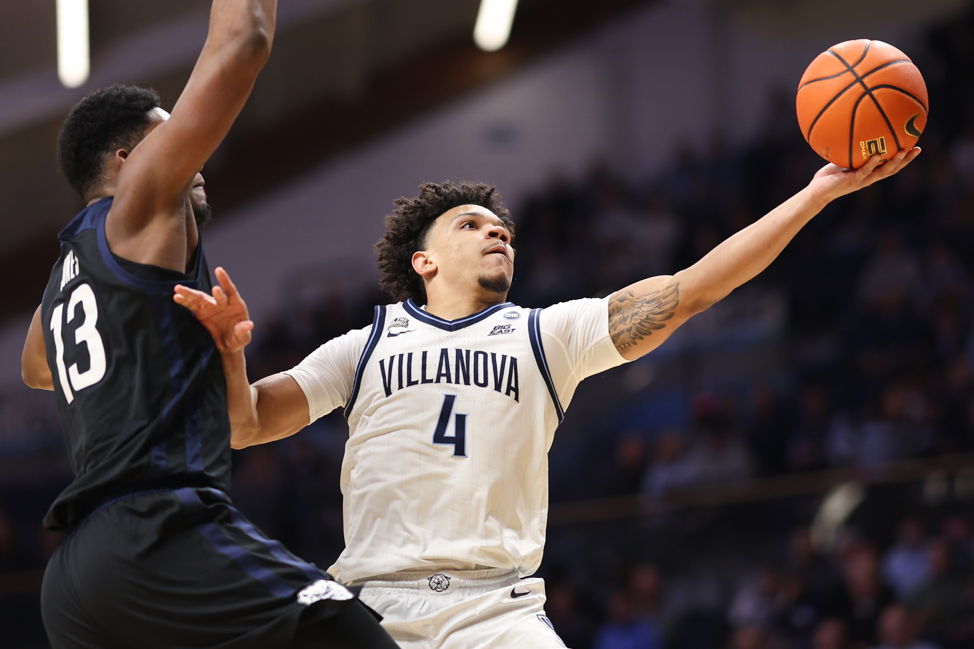 Villanova Wildcats guard Tyler Perkins (4) drives for a shot as we break down our College Basketball predictions.