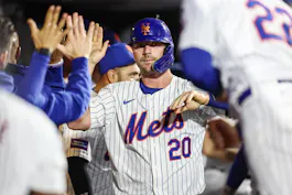 New York Mets pinch-hitter Pete Alonso celebrates with teammates in the dugout after scoring the tying run in the seventh inning against the Arizona Diamondbacks at Citi Field as we look at our home run props for Tuesday.