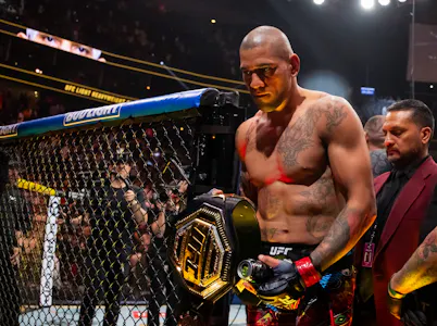 Alex Pereira celebrates with the championship belt as we look at the full UFC 303 card betting odds & lines.