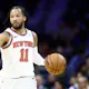 Jalen Brunson of the New York Knicks dribbles during the third quarter against the Philadelphia 76ers at the Wells Fargo Center as we look at our Celtics-Knicks promo code for BetRivers.